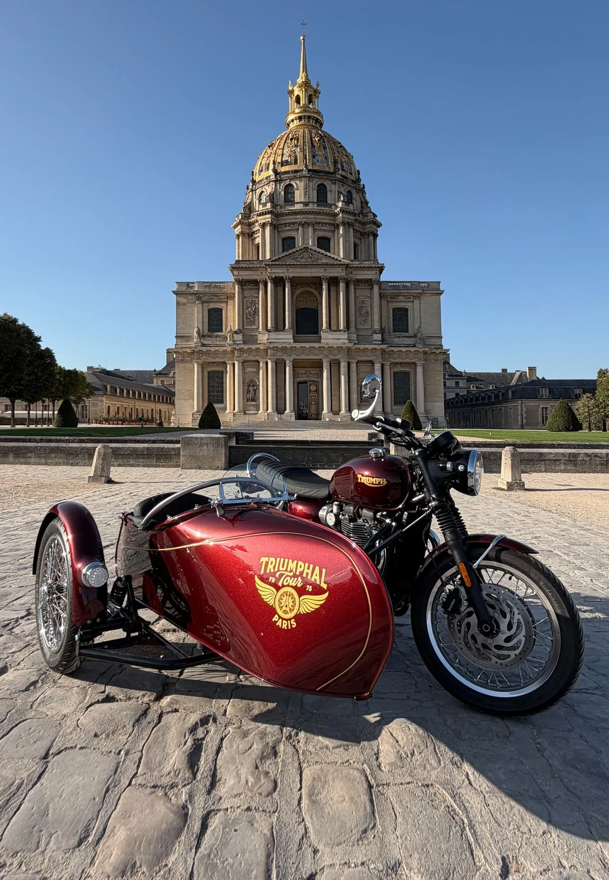 Red Iconic Tour Triumph sidecar in front of Les Invalides